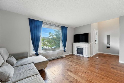 123 Silverstone Road Nw, Calgary, AB - Indoor Photo Showing Living Room With Fireplace