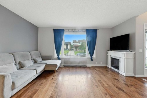 123 Silverstone Road Nw, Calgary, AB - Indoor Photo Showing Living Room With Fireplace