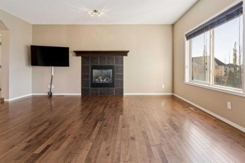 34 Kingsland Close, Airdrie, AB - Indoor Photo Showing Living Room With Fireplace