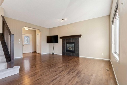 34 Kingsland Close, Airdrie, AB - Indoor Photo Showing Living Room With Fireplace