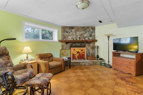 124 Lynnbrook Road Se, Calgary, AB - Indoor Photo Showing Living Room With Fireplace