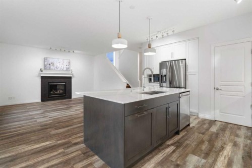 248 Ranch Close, Strathmore, AB - Indoor Photo Showing Kitchen With Fireplace