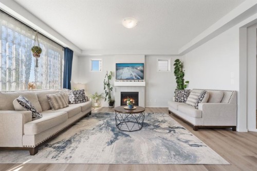 633 Windrow Manor Sw, Airdrie, AB - Indoor Photo Showing Living Room With Fireplace