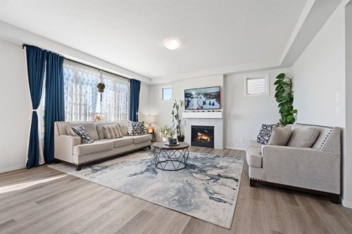 633 Windrow Manor Sw, Airdrie, AB - Indoor Photo Showing Living Room With Fireplace