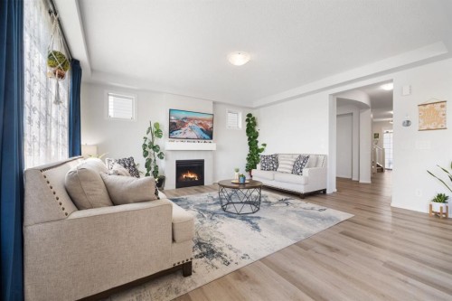 633 Windrow Manor Sw, Airdrie, AB - Indoor Photo Showing Living Room With Fireplace