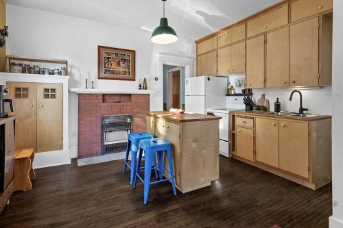 1038 1 Avenue Nw, Calgary, AB - Indoor Photo Showing Kitchen With Fireplace