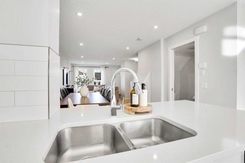 128 Cranbrook Square Se, Calgary, AB - Indoor Photo Showing Kitchen With Double Sink
