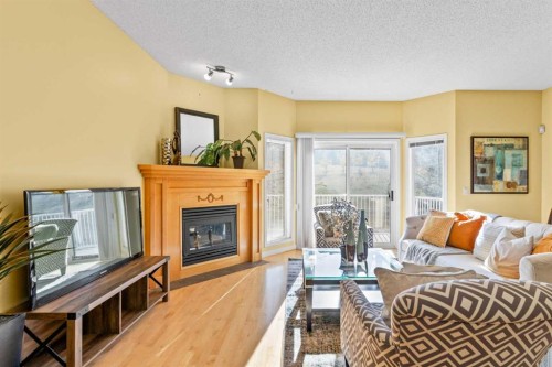147 Hampstead Green Nw, Calgary, AB - Indoor Photo Showing Living Room With Fireplace