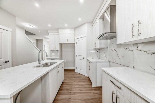 144 Belvedere Park Se, Calgary, AB - Indoor Photo Showing Kitchen With Double Sink
