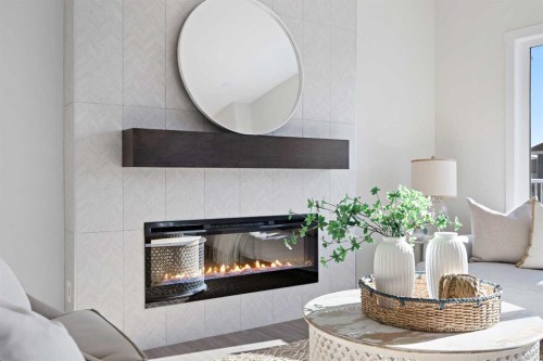 1398 Bayview Crescent Sw, Airdrie, AB - Indoor Photo Showing Living Room With Fireplace