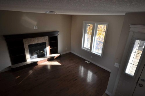 114 Silverado Plains Manor Sw, Calgary, AB - Indoor Photo Showing Living Room With Fireplace