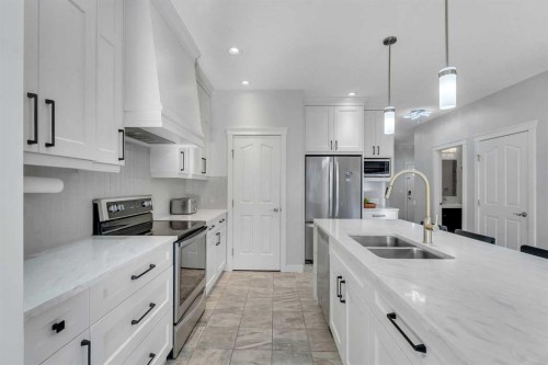 1535 Ravensmoor Way Se, Airdrie, AB - Indoor Photo Showing Kitchen With Double Sink With Upgraded Kitchen