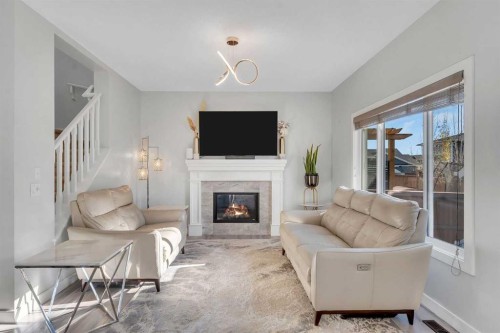 1535 Ravensmoor Way Se, Airdrie, AB - Indoor Photo Showing Living Room With Fireplace