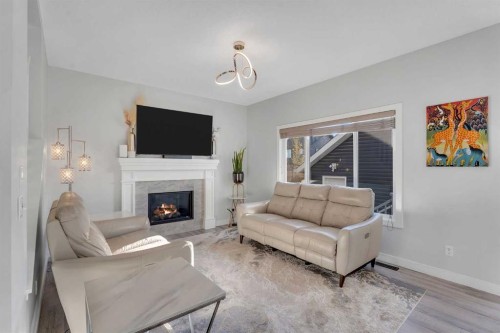 1535 Ravensmoor Way Se, Airdrie, AB - Indoor Photo Showing Living Room With Fireplace