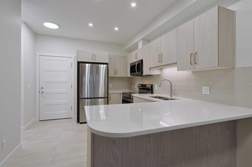 1401-81 Arbour Lake View Nw, Calgary, AB - Indoor Photo Showing Kitchen With Stainless Steel Kitchen With Double Sink