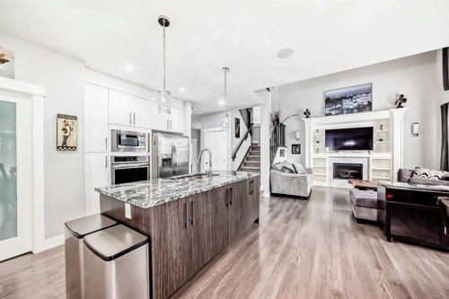 1368 Lackner Boulevard, Carstairs, AB - Indoor Photo Showing Kitchen With Fireplace With Upgraded Kitchen
