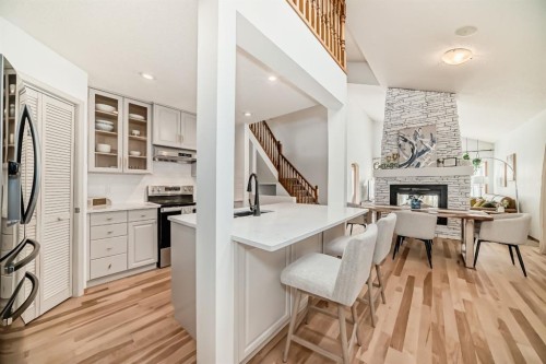 58 Panatella Lane Nw, Calgary, AB - Indoor Photo Showing Kitchen With Fireplace