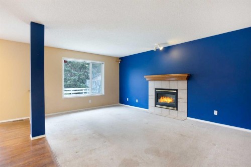 29 Spring Crescent Sw, Calgary, AB - Indoor Photo Showing Living Room With Fireplace