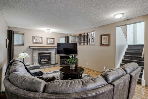 47 Harvest Glen Rise Ne, Calgary, AB - Indoor Photo Showing Living Room With Fireplace