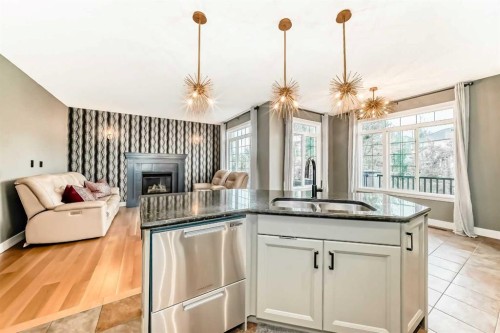 2 Tuscany Estates Crescent Nw, Calgary, AB - Indoor Photo Showing Kitchen With Fireplace With Double Sink