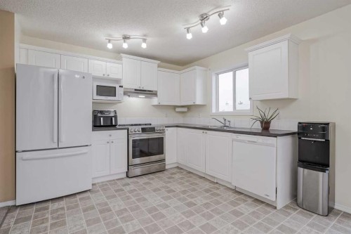 4 Bridleridge Circle Sw, Calgary, AB - Indoor Photo Showing Kitchen With Double Sink