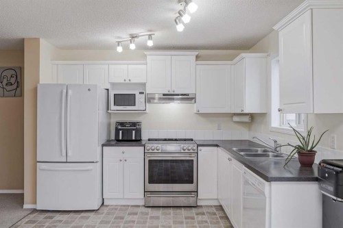 4 Bridleridge Circle Sw, Calgary, AB - Indoor Photo Showing Kitchen With Double Sink