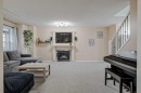 4 Bridleridge Circle Sw, Calgary, AB  - Indoor Photo Showing Living Room With Fireplace 