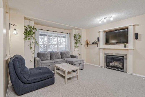 4 Bridleridge Circle Sw, Calgary, AB - Indoor Photo Showing Living Room With Fireplace