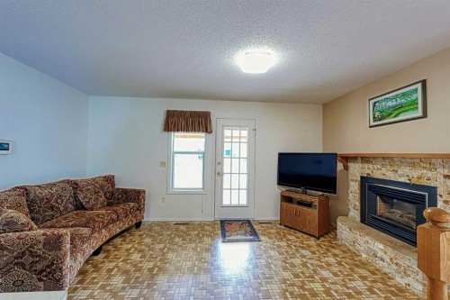 21 Welch Crescent, Okotoks, AB - Indoor Photo Showing Living Room With Fireplace