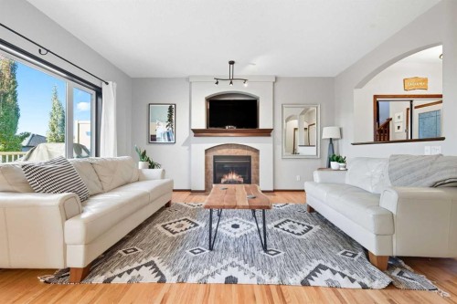 155 Sunset Close, Cochrane, AB - Indoor Photo Showing Living Room With Fireplace