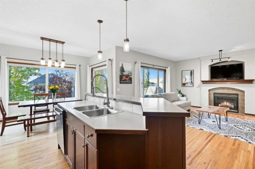 155 Sunset Close, Cochrane, AB - Indoor Photo Showing Kitchen With Fireplace With Double Sink