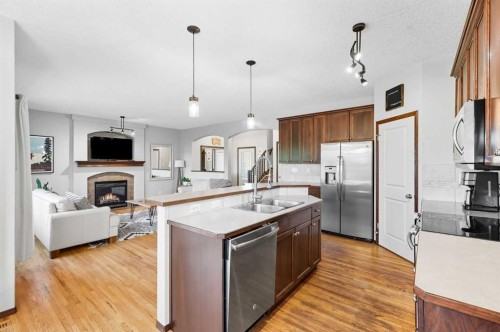 155 Sunset Close, Cochrane, AB - Indoor Photo Showing Kitchen With Fireplace With Upgraded Kitchen