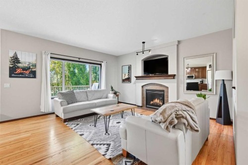 155 Sunset Close, Cochrane, AB - Indoor Photo Showing Living Room With Fireplace