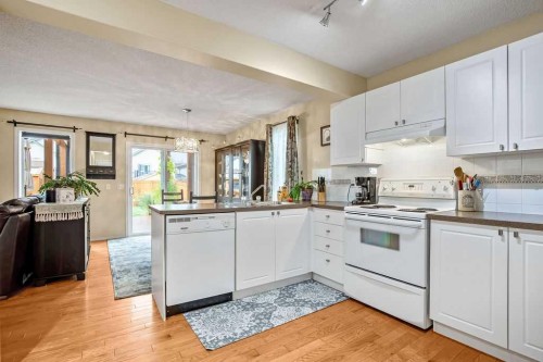 85 Bridleridge Road Sw, Calgary, AB - Indoor Photo Showing Kitchen With Double Sink