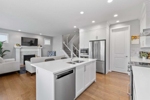 240 Cranbrook Circle Se, Calgary, AB - Indoor Photo Showing Kitchen With Fireplace With Stainless Steel Kitchen With Double Sink With Upgraded Kitchen