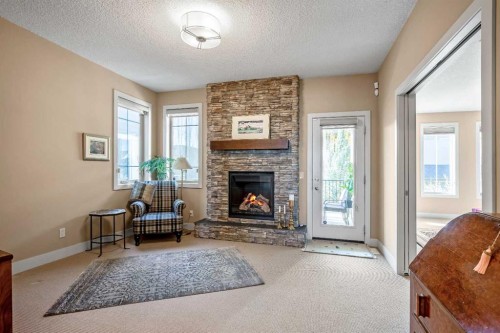 116 Wentworth Square Sw, Calgary, AB - Indoor Photo Showing Living Room With Fireplace
