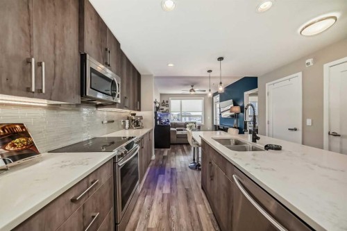 312-8530 8A Avenue Sw, Calgary, AB - Indoor Photo Showing Kitchen With Stainless Steel Kitchen With Double Sink With Upgraded Kitchen