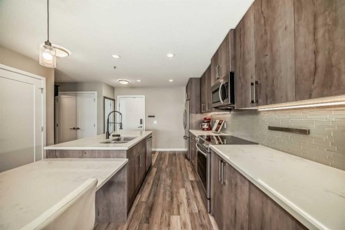 312-8530 8A Avenue Sw, Calgary, AB - Indoor Photo Showing Kitchen With Double Sink With Upgraded Kitchen