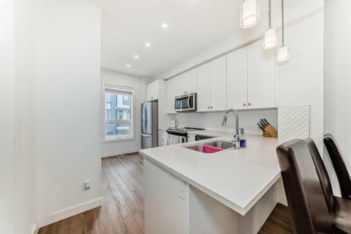 208-15 Evanscrest Park Nw, Calgary, AB - Indoor Photo Showing Kitchen With Stainless Steel Kitchen With Double Sink With Upgraded Kitchen