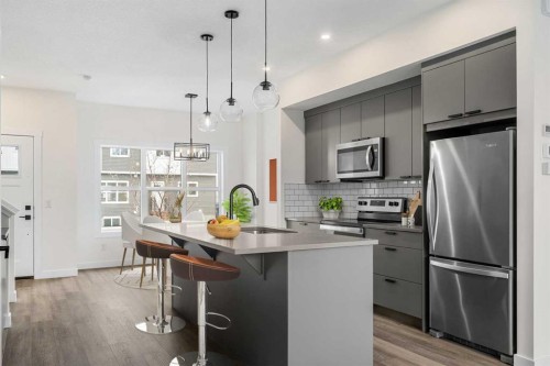 1206-525 River Heights Drive, Cochrane, AB - Indoor Photo Showing Kitchen With Stainless Steel Kitchen With Upgraded Kitchen