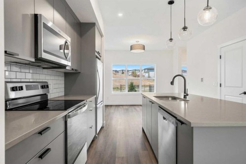 1206-525 River Heights Drive, Cochrane, AB - Indoor Photo Showing Kitchen With Stainless Steel Kitchen With Upgraded Kitchen
