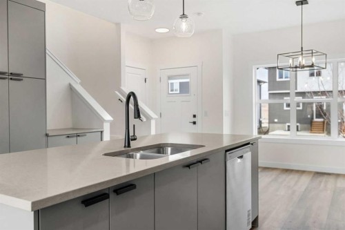 1206-525 River Heights Drive, Cochrane, AB - Indoor Photo Showing Kitchen With Double Sink