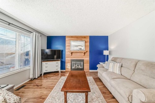344 Copperfield Boulevard Se, Calgary, AB - Indoor Photo Showing Living Room With Fireplace