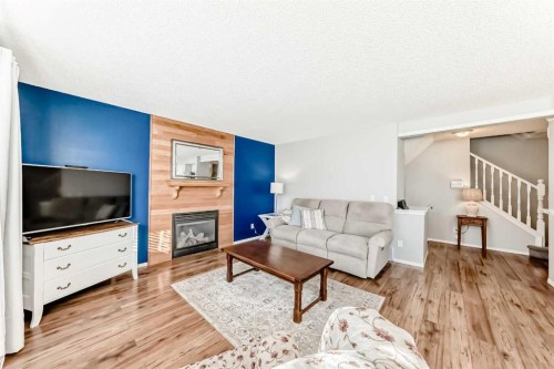 344 Copperfield Boulevard Se, Calgary, AB - Indoor Photo Showing Living Room With Fireplace