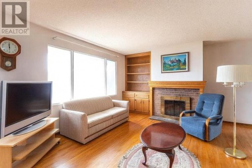 7803 Hunterslea Crescent Nw, Calgary, AB - Indoor Photo Showing Living Room With Fireplace