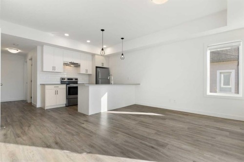 605-24 Rivercrest Drive, Cochrane, AB - Indoor Photo Showing Kitchen With Upgraded Kitchen