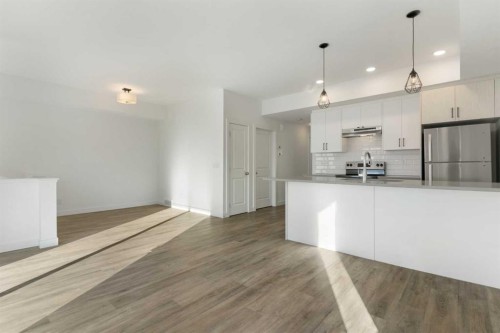 605-24 Rivercrest Drive, Cochrane, AB - Indoor Photo Showing Kitchen With Upgraded Kitchen