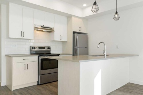 605-24 Rivercrest Drive, Cochrane, AB - Indoor Photo Showing Kitchen With Upgraded Kitchen