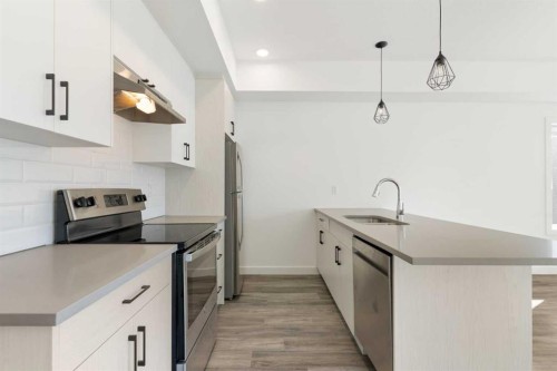 605-24 Rivercrest Drive, Cochrane, AB - Indoor Photo Showing Kitchen With Upgraded Kitchen