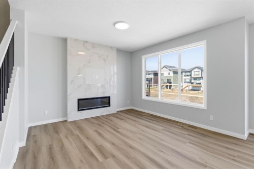 132 Lewiston Drive Ne, Calgary, AB - Indoor Photo Showing Living Room With Fireplace